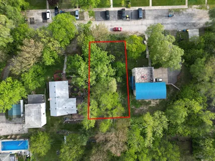 an aerial view of a house with a yard and lake view