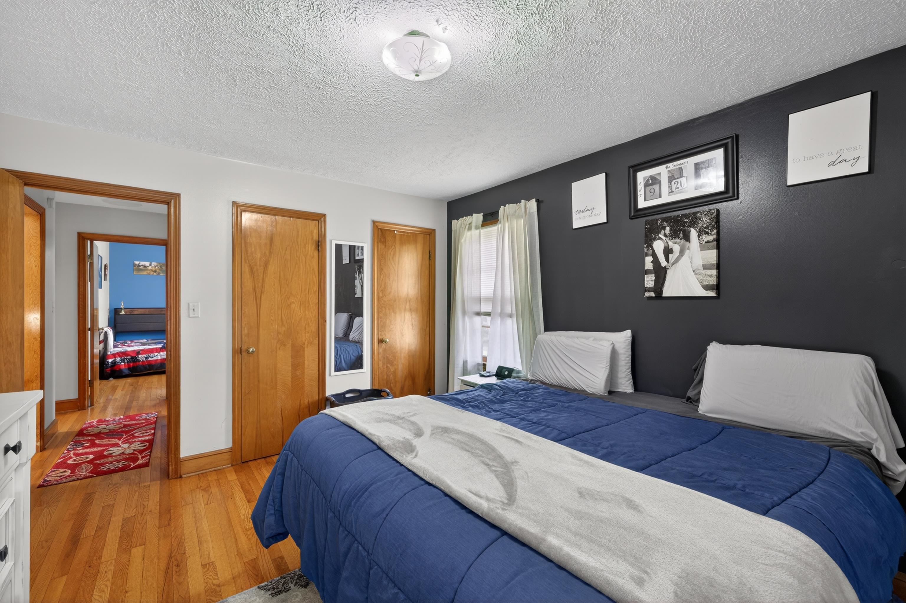 7827 Lee Highway Raphine, VA 24472 - Photo 29 of 62 a bedroom with a large bed and a chandelier