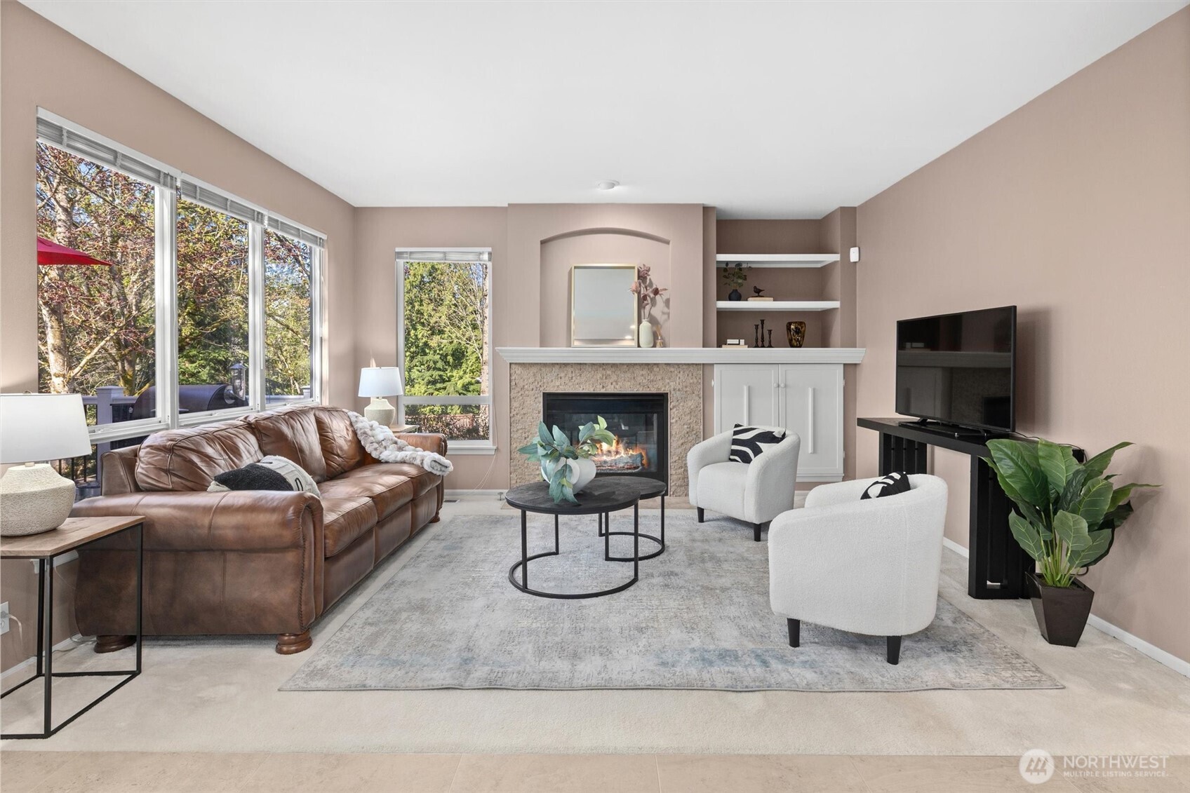 2708 204th Street Southeast Bothell, WA 98021 - Photo 14 of 40 a living room with furniture a fireplace and a flat screen tv