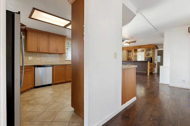 a kitchen with a refrigerator and microwave