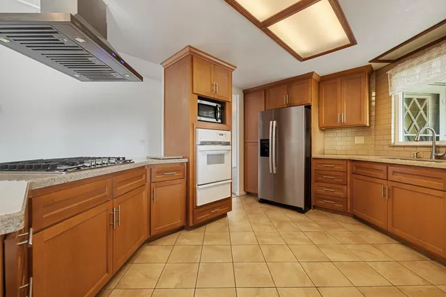 a kitchen with stainless steel appliances granite countertop a stove and a microwave