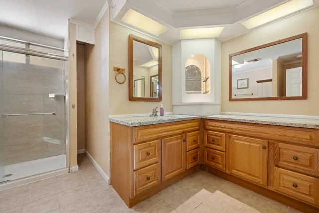 a bathroom with a glass shower door
