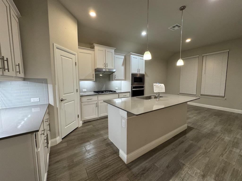 3432 Cornerstone Lane Midlothian, TX 76065 - Photo 12 of 40 a kitchen with kitchen island granite countertop a sink a counter top space stainless steel appliances and cabinets