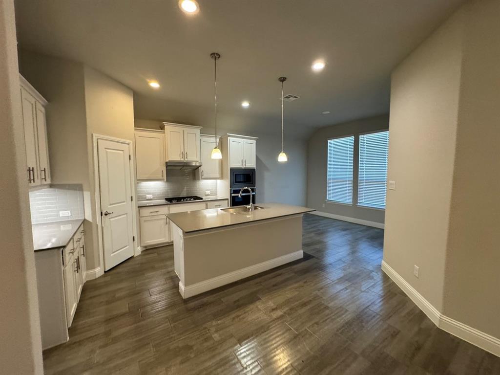3432 Cornerstone Lane Midlothian, TX 76065 - Photo 13 of 40 a large kitchen with stainless steel appliances a large counter top a stove and a refrigerator