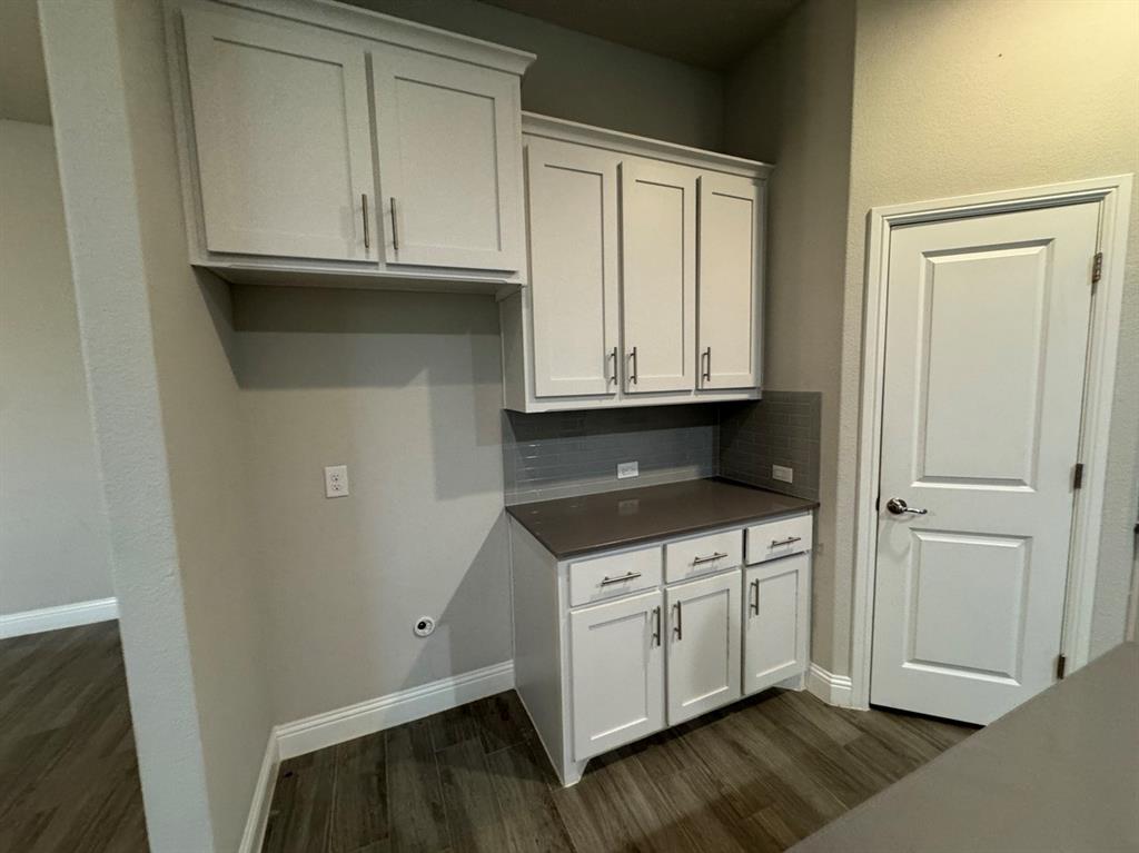 3432 Cornerstone Lane Midlothian, TX 76065 - Photo 21 of 40 a kitchen with granite countertop white cabinets and a sink