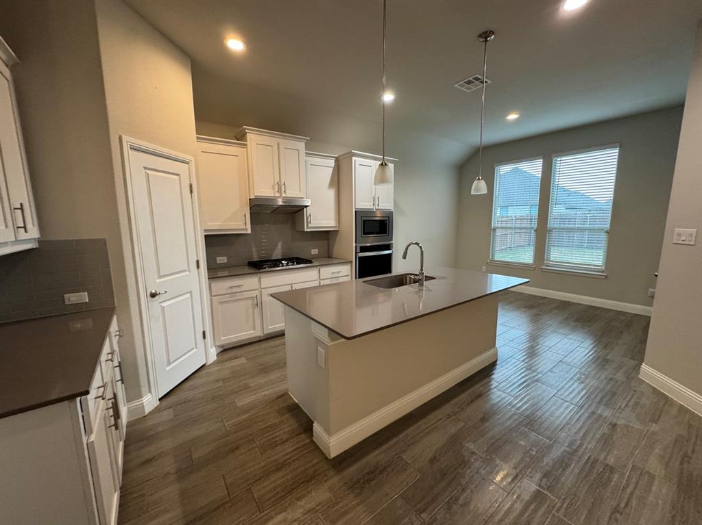 3432 Cornerstone Lane Midlothian, TX 76065 - Photo 27 of 40 a kitchen with stainless steel appliances granite countertop a refrigerator a sink dishwasher a stove and a refrigerator with wooden floor