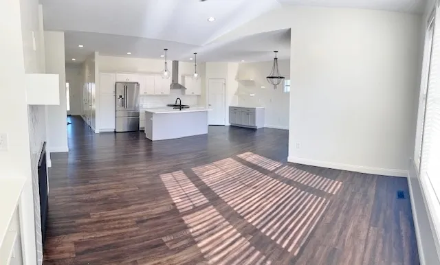 a view of a yard in front of a house with large trees