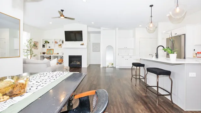 a living room with furniture a fireplace and a flat screen tv