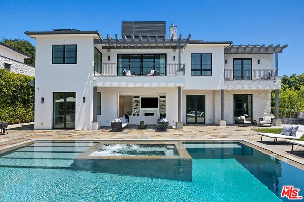 a view of a house with pool porch and chairs