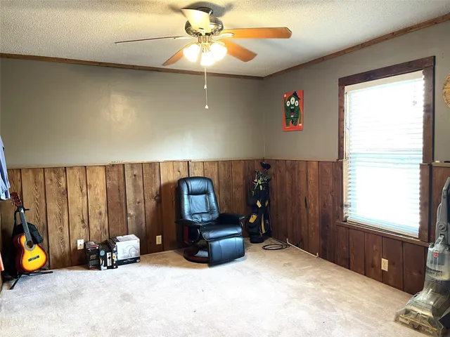 a view of a room with gym equipment and a large window