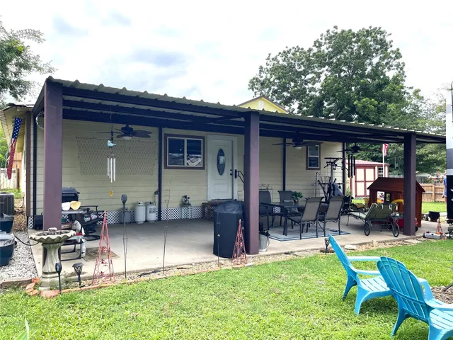 a view of a house with backyard porch and sitting area