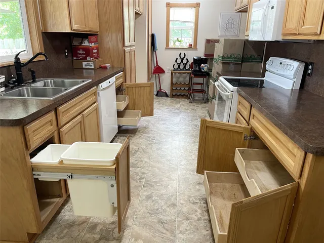 a kitchen with a sink and a stove top oven