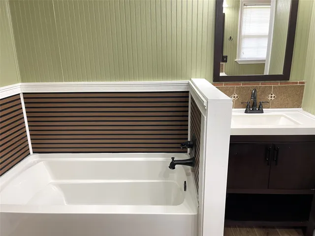 a bathroom with a bathtub and a sink