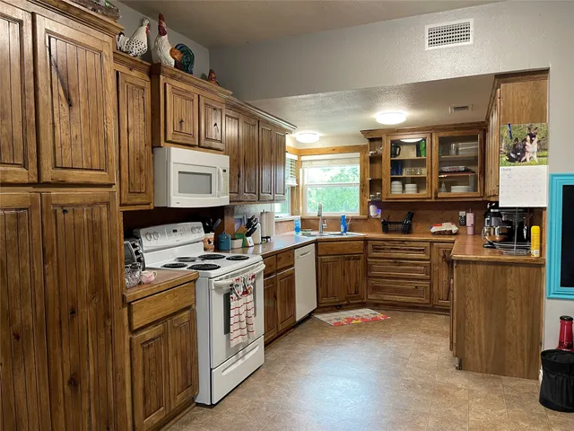 a kitchen with stainless steel appliances a stove sink and cabinets
