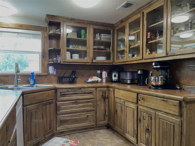 a kitchen with stainless steel appliances granite countertop a sink and cabinets