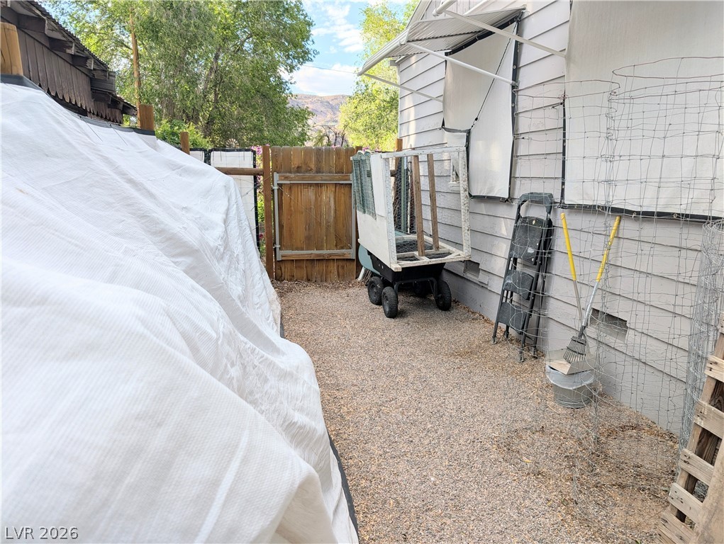 102 Rowan Drive Caliente, NV 89008 - Photo 22 of 28 A gravel side yard provides functional outdoor space between structures.