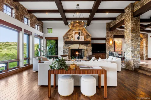 a living room with furniture a fireplace and wooden floor
