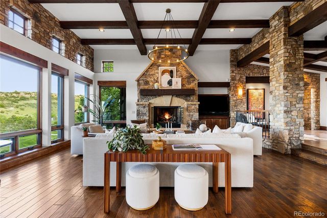 a living room with furniture a fireplace and wooden floor