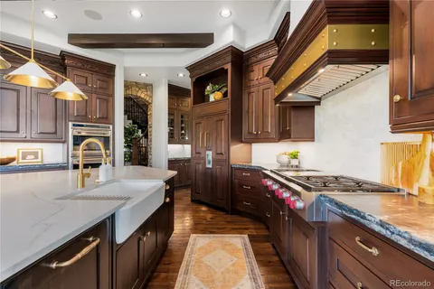 a kitchen with stainless steel appliances granite countertop a stove and a sink