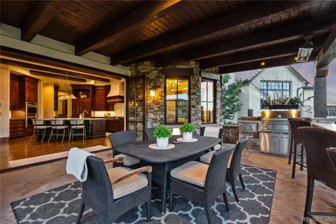 a dining room with furniture and a floor to ceiling window