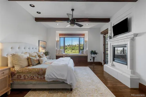 a spacious bedroom with a bed and a flat screen tv