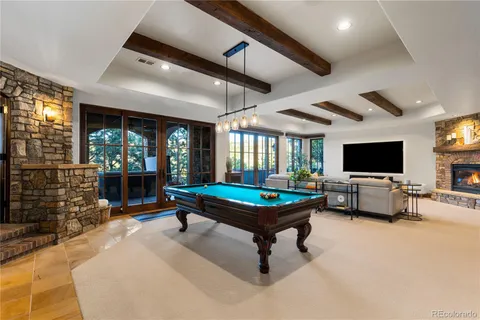 a living room with furniture a flat screen tv and a large window