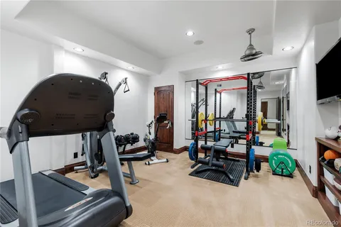a room with gym equipment and a mirror