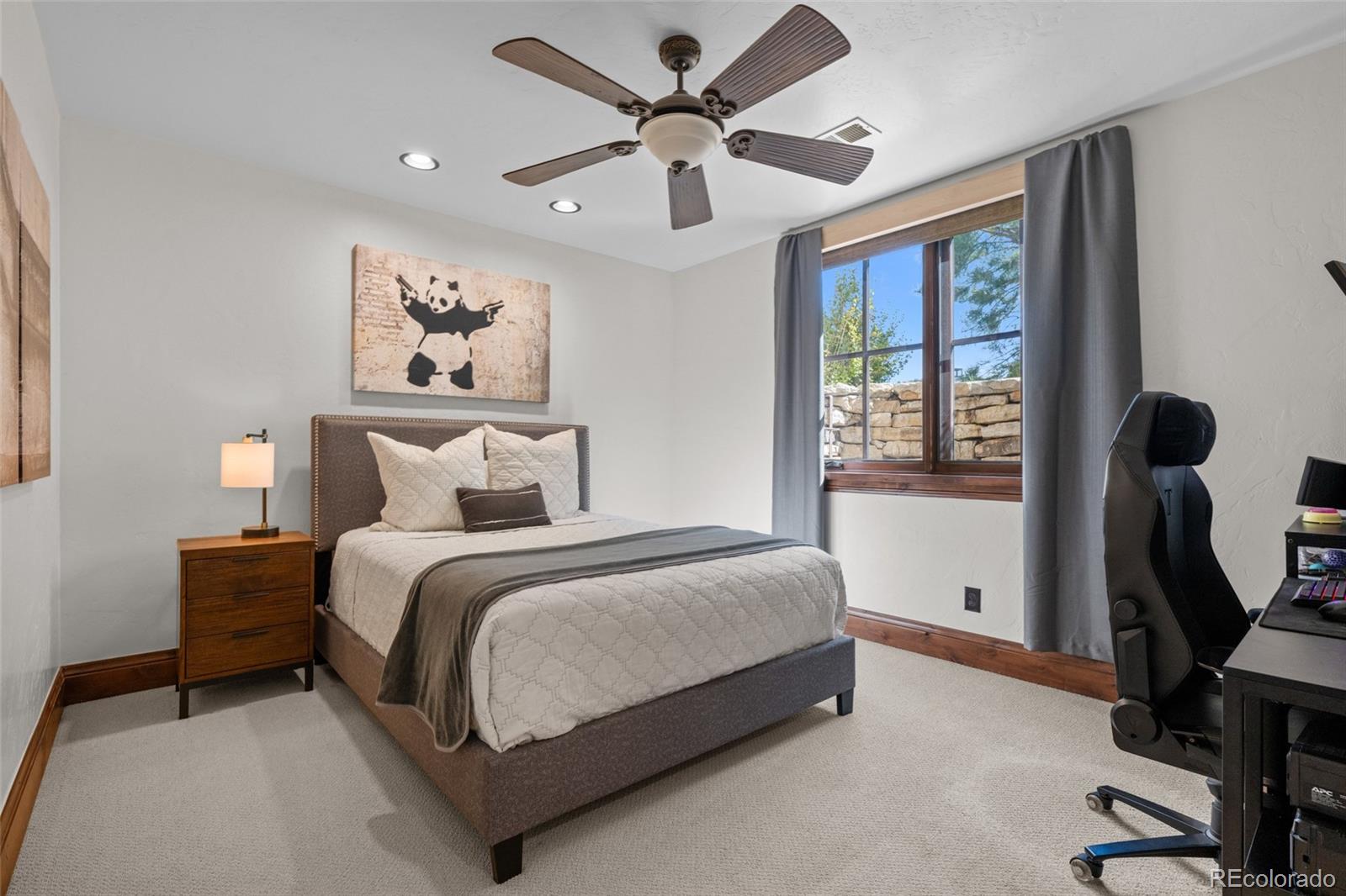 7208 Raphael Lane Littleton, CO 80125 - Photo 38 of 47 a spacious bedroom with a bed and a window