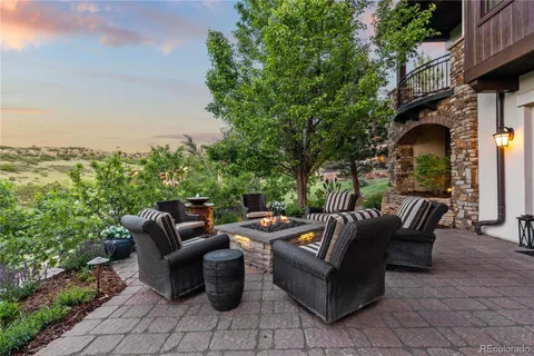 a view of a patio with couches and a fire pit