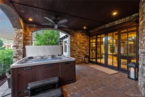 a view of a porch with furniture and a yard
