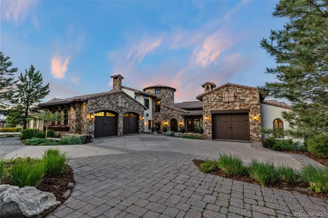 a front view of a house with a yard and a garage