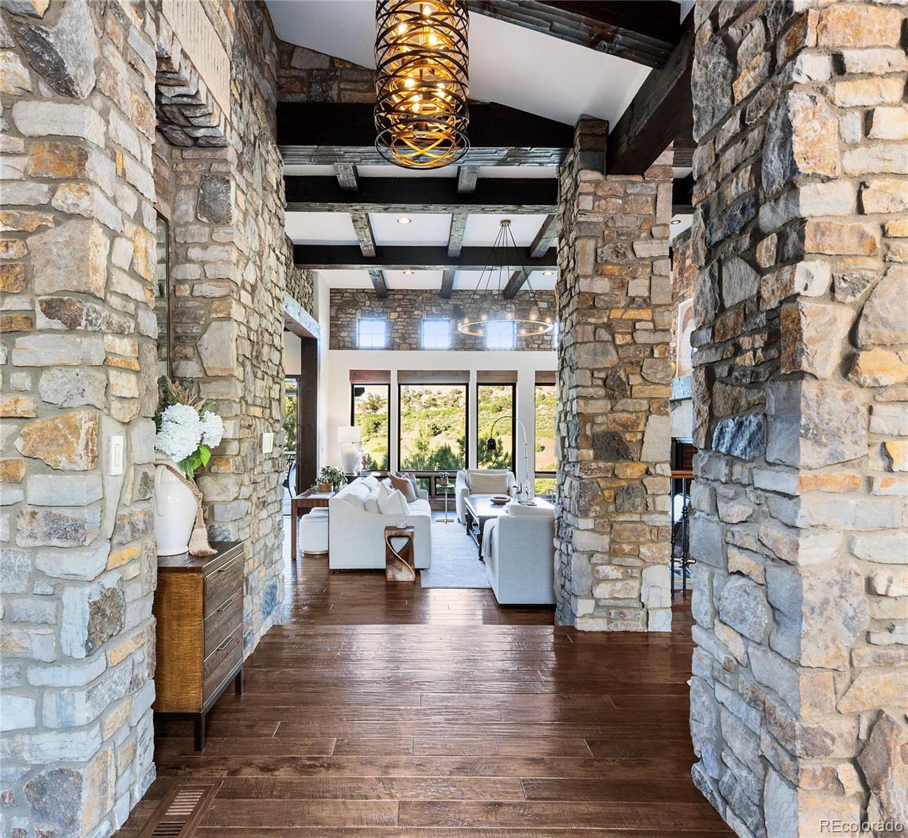 7208 Raphael Lane Littleton, CO 80125 - Photo 8 of 47 a view of an empty room with wooden floor