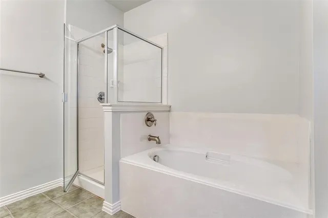 a white bath tub sitting next to a shower
