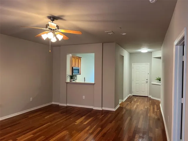 a view of an empty room and wooden floor