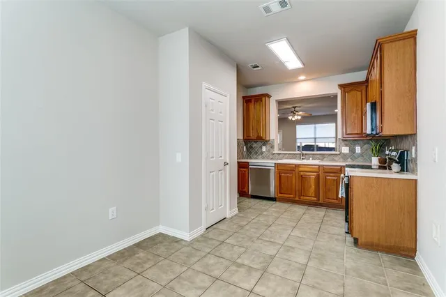 a kitchen with a sink a counter top space and cabinets