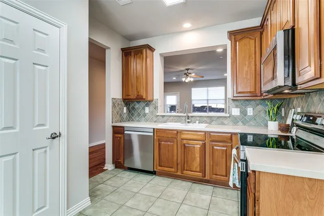 a kitchen with stainless steel appliances granite countertop a sink and cabinets