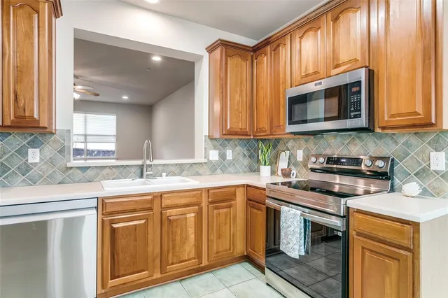 a kitchen with stainless steel appliances granite countertop a sink stove and microwave