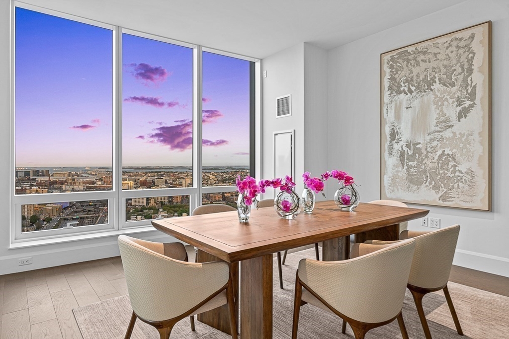 40 Trinity Place, Unit PH34D Boston, MA 02116 - Photo 11 of 37 a view of a dining room with furniture window and wooden floor