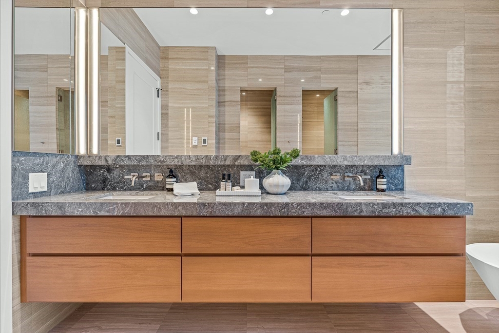 40 Trinity Place, Unit PH34D Boston, MA 02116 - Photo 14 of 37 a bathroom with a granite countertop sink and a mirror