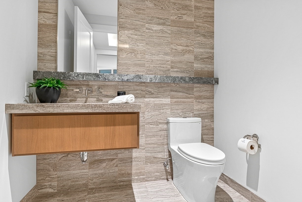 40 Trinity Place, Unit PH34D Boston, MA 02116 - Photo 23 of 37 a bathroom with a toilet a sink and mirror