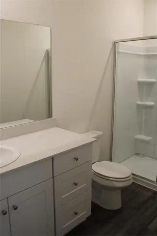 a bathroom with a toilet a sink and shower