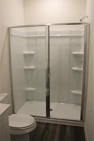 a bathroom with a glass shower door