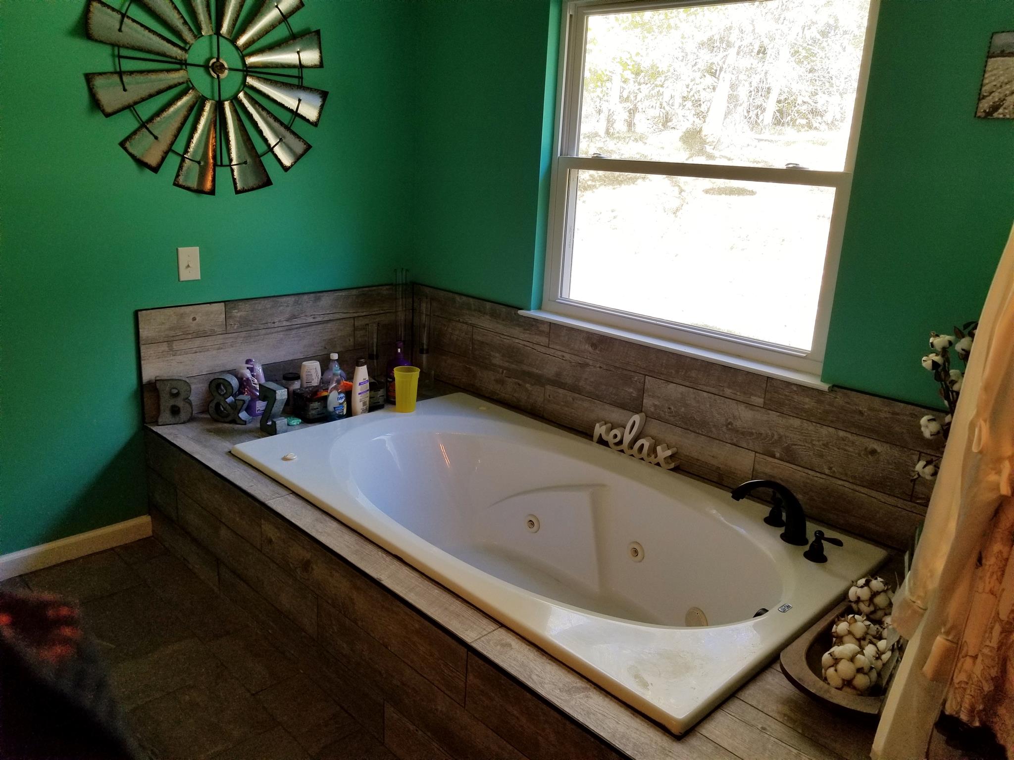 2807 Henry Gower Road Pleasant View, TN 37146 - Photo 26 of 30 a bathroom with a bathtub and a window