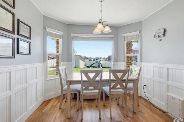 860 West 2980th Street South Logan, UT 84321 - Photo 11 of 38 Bay window dining area featuring wood-finish flooring and white wainscoting