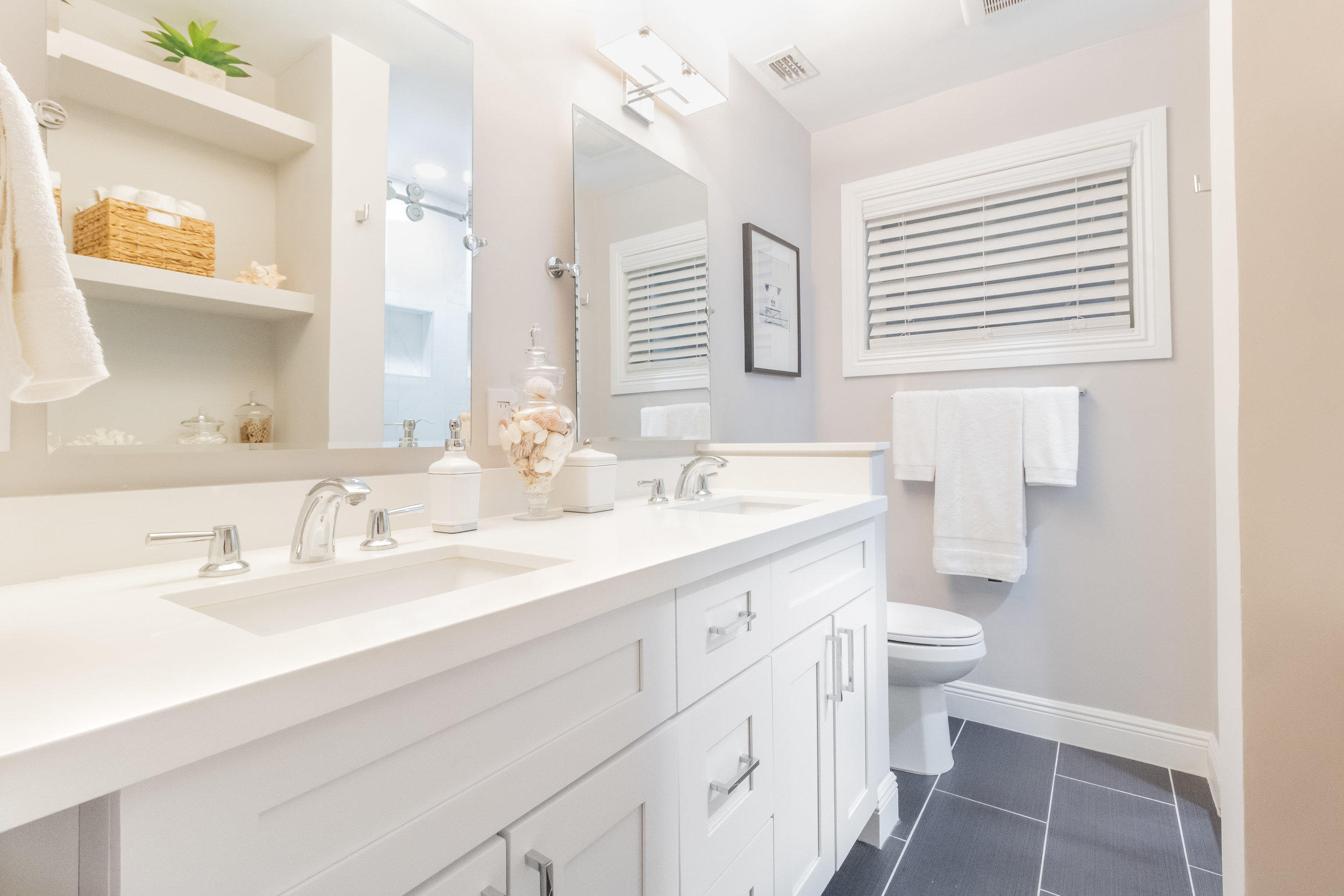 1241 Southwest 8th Street Boca Raton, FL 33486 - Photo 14 of 22 a bathroom with a double vanity sink mirror and toilet