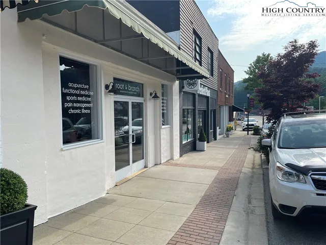 a view of a building with car parked