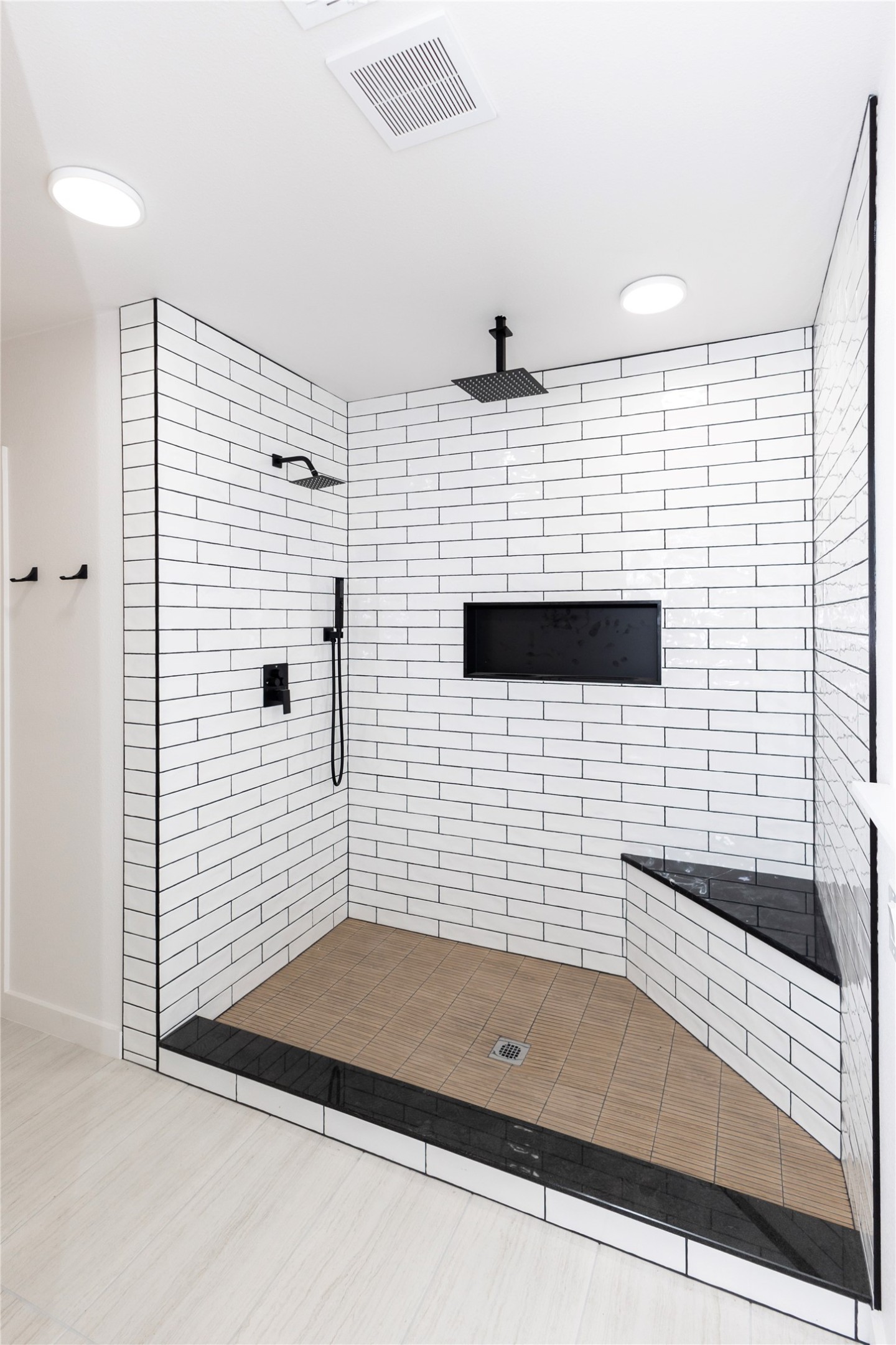 205 Bello Circle Georgetown, TX 78628 - Photo 24 of 36 A striking corner shower features subway tile walls, dual shower heads, and a built-in bench.