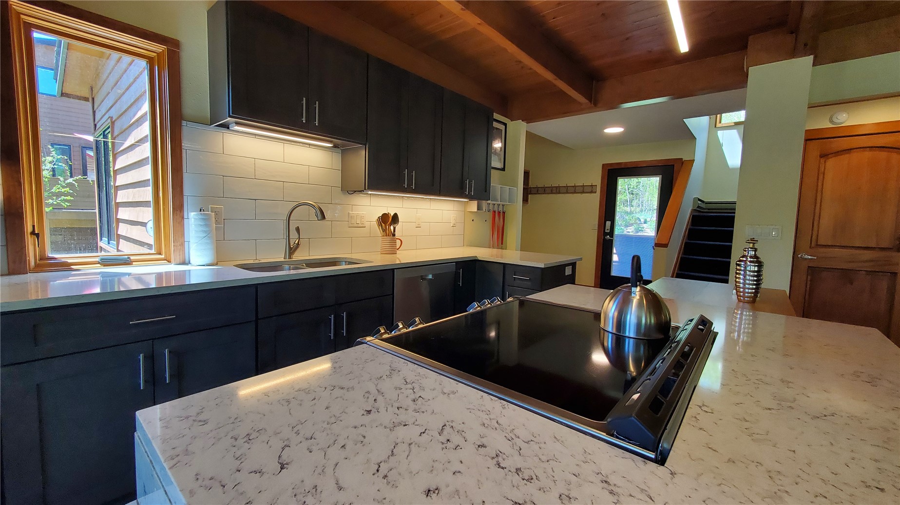 620 Tennis Club Road, Unit 1337 Keystone, CO 80435 - Photo 2 of 48 a kitchen with a sink and wooden cabinets