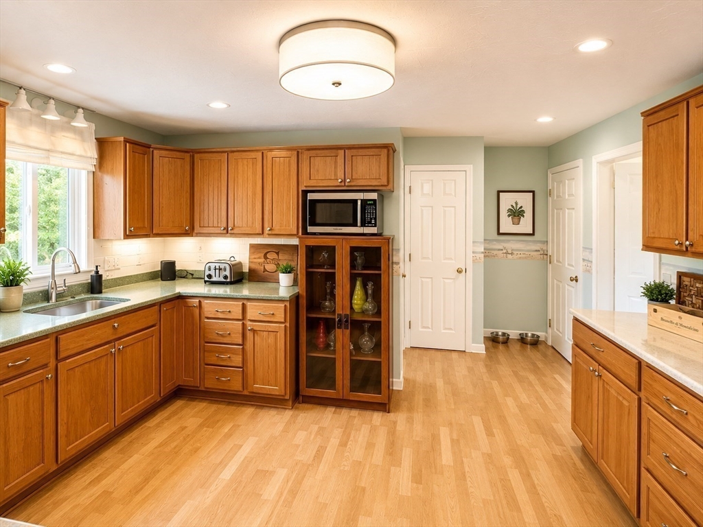 38 Crescent Road, Unit 38 Needham, MA 02494 - Photo 4 of 23 a kitchen with stainless steel appliances granite countertop a stove a sink and a refrigerator