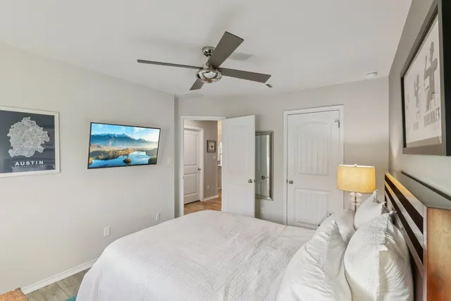 a bedroom with a bed and a chandelier